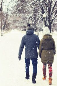 Couple walking through snow